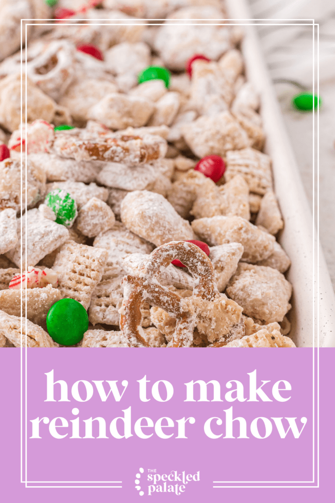 Close up of Christmas Puppy Chow on a sheet pan with pretzels and M&Ms with the text how to make reindeer chow