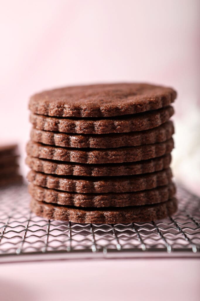 A stack of Chocolate Sugar Cookies on a wire cooling rack