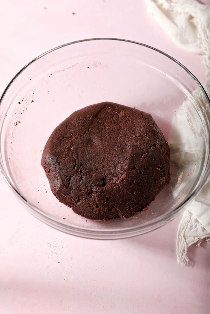 A round of chocolate sugar cookie dough in a bowl