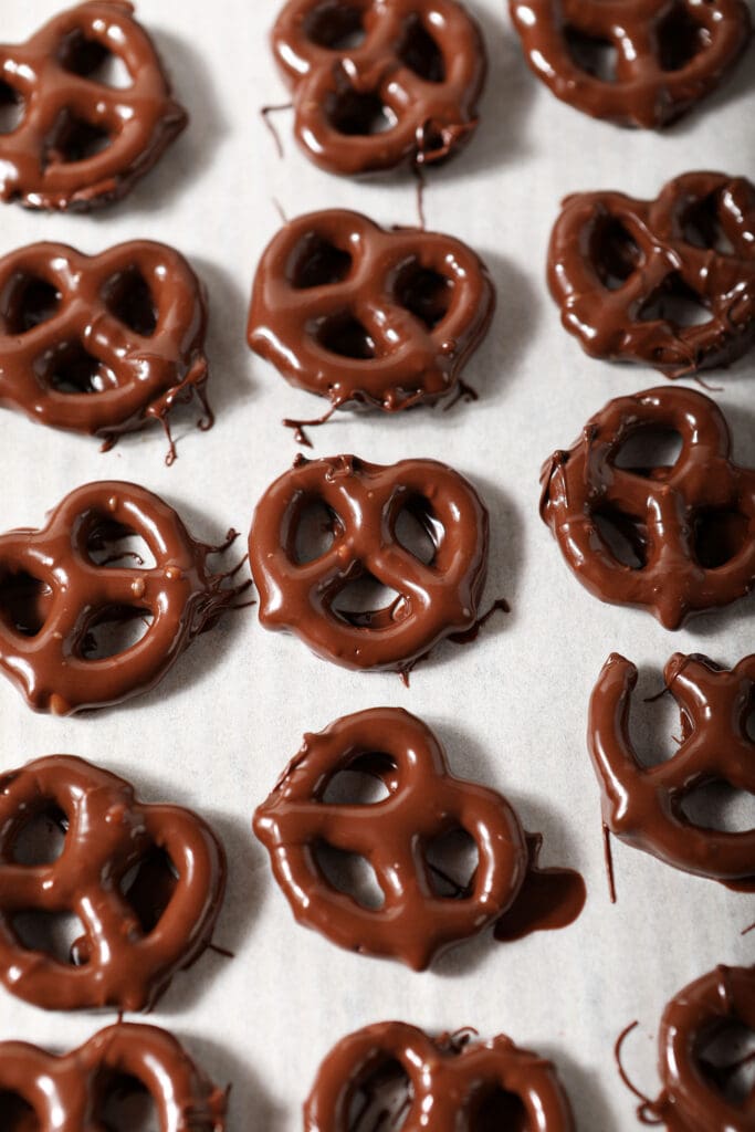 Chocolate Covered Pretzels cooling on parchment