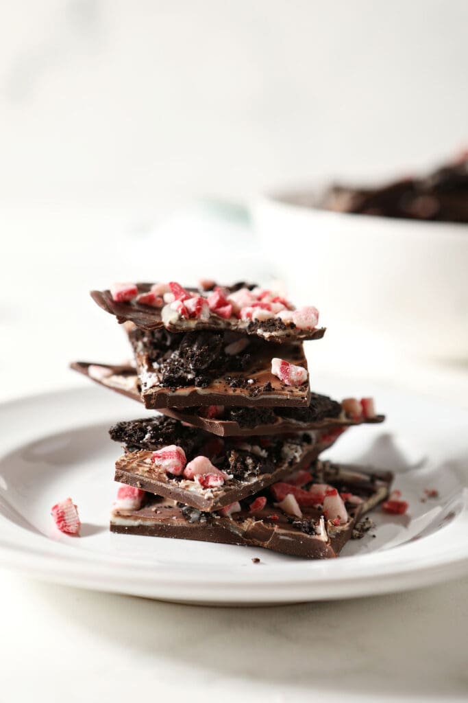 Stacked pieces of Oreo Peppermint Bark on a white plate