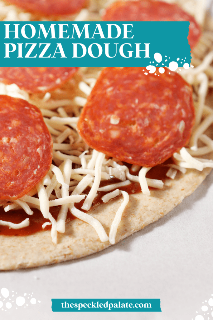 Close up of pizza dough topped with sauce, cheese and pepperoni on parchment before baking with the text homemade pizza dough