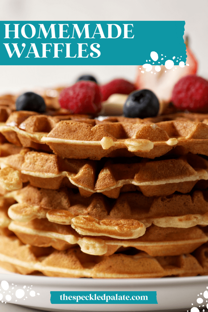 Close up of a stack of waffles topped with berries with the text homemade waffles