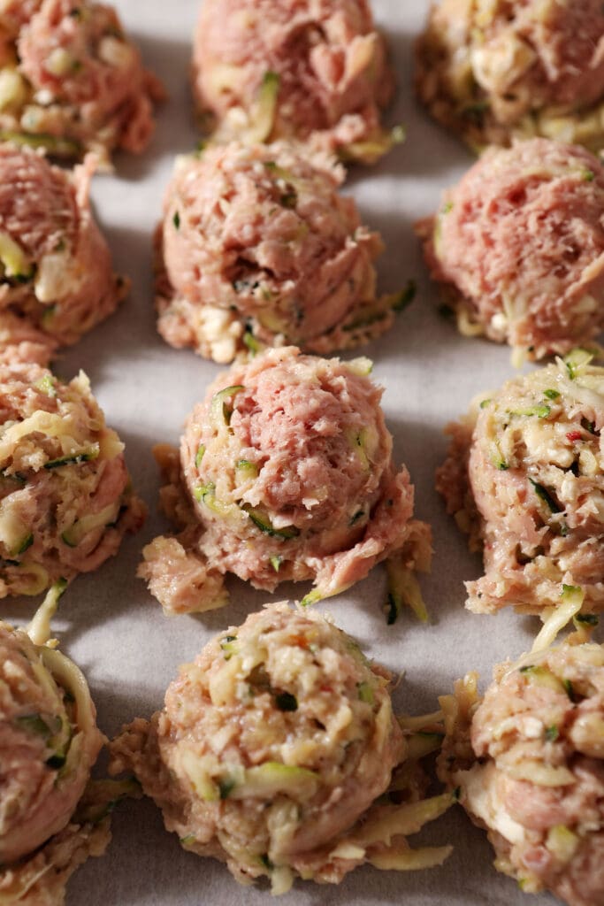 Turkey zucchini meatballs on a baking sheet before baking