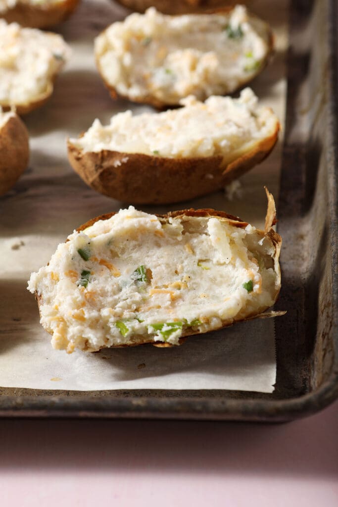 Filled twice baked potatoes before baking on a sheet pan