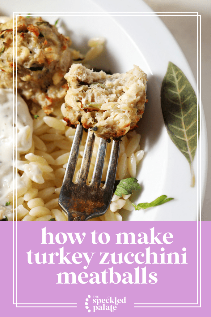 A bitten-into zucchini meatball on a fork dips into a dollop of tzatziki in orzo pasta with the text how to make turkey zucchini meatballs