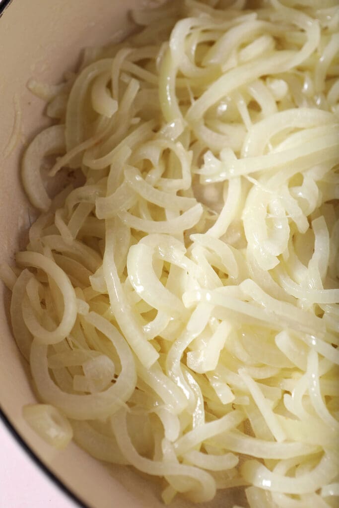 Sliced onions begin to sweat in a braised pan