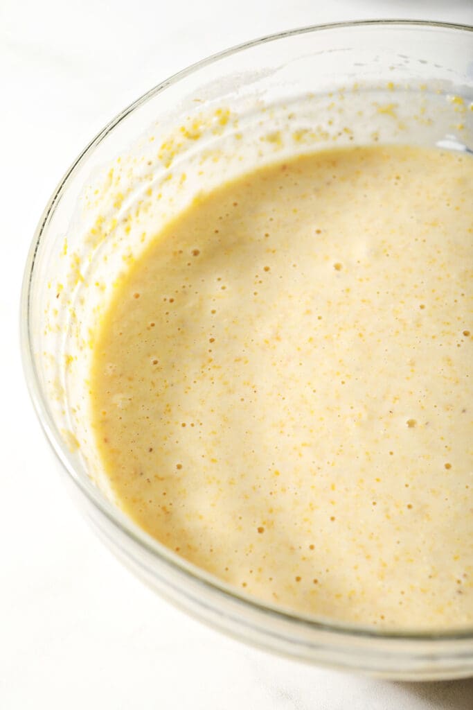 Cornbread muffin batter in a bowl on marble