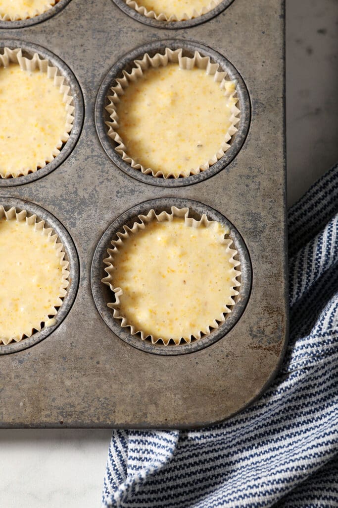 Cornbread muffin batter in a muffin tin before baking