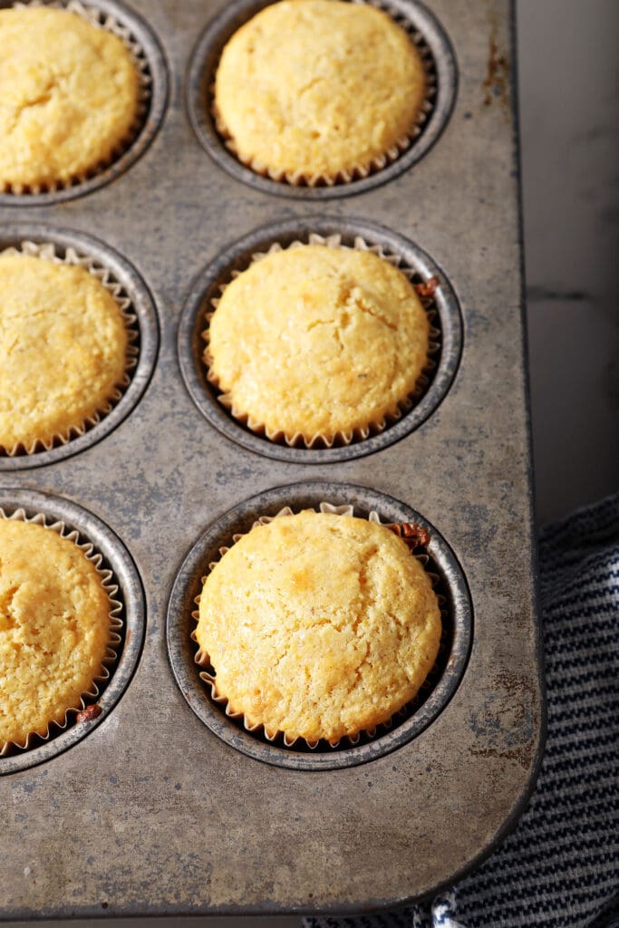 Cornbread muffins in a muffin tin after baking