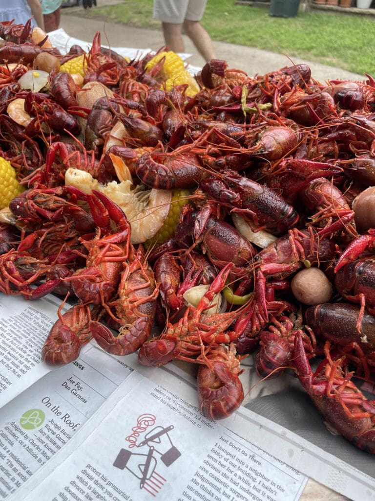 boiled crawfish on a newspaper-lined table