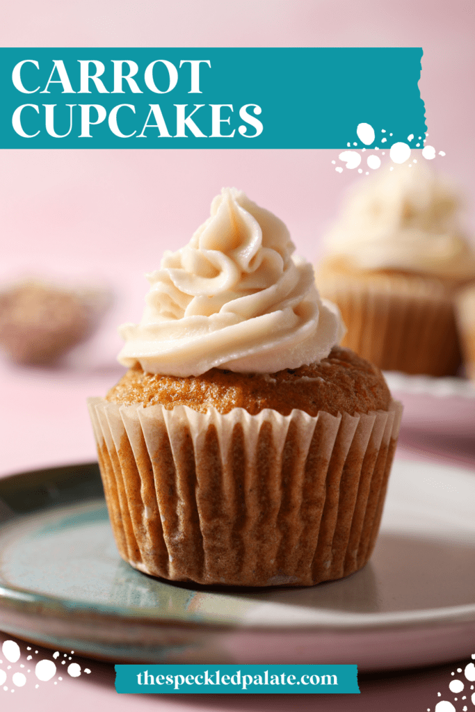 Close up of a carrot cupcake frosted with cream cheese frosting on a colorful plate with the text carrot cupcakes