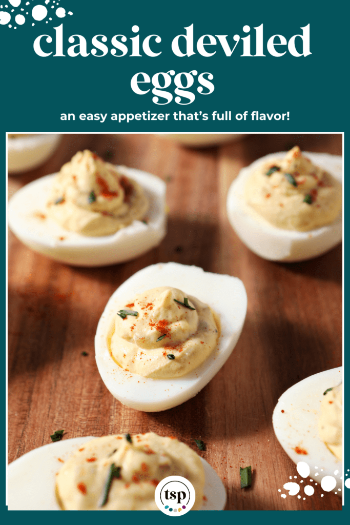 Close up of deviled eggs on a wooden board with the text classic deviled eggs and easy appetizer that's full of flavor