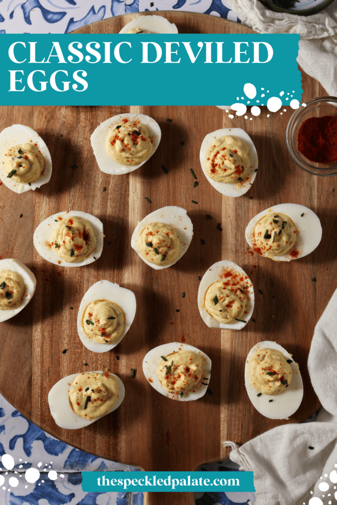 Deviled eggs on a wooden platter from above on a blue and white tile surface with the text classic deviled eggs