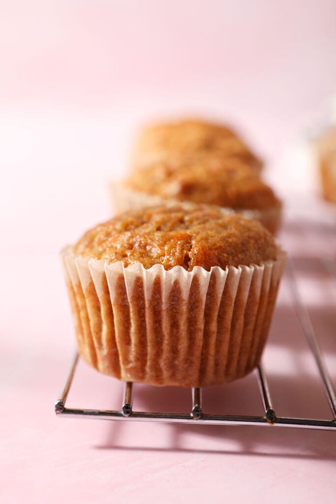 Carrot cupcakes cool on a wire rack