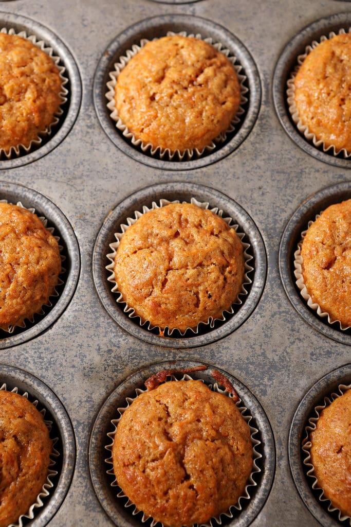 Carrot cupcakes in a tin after baking