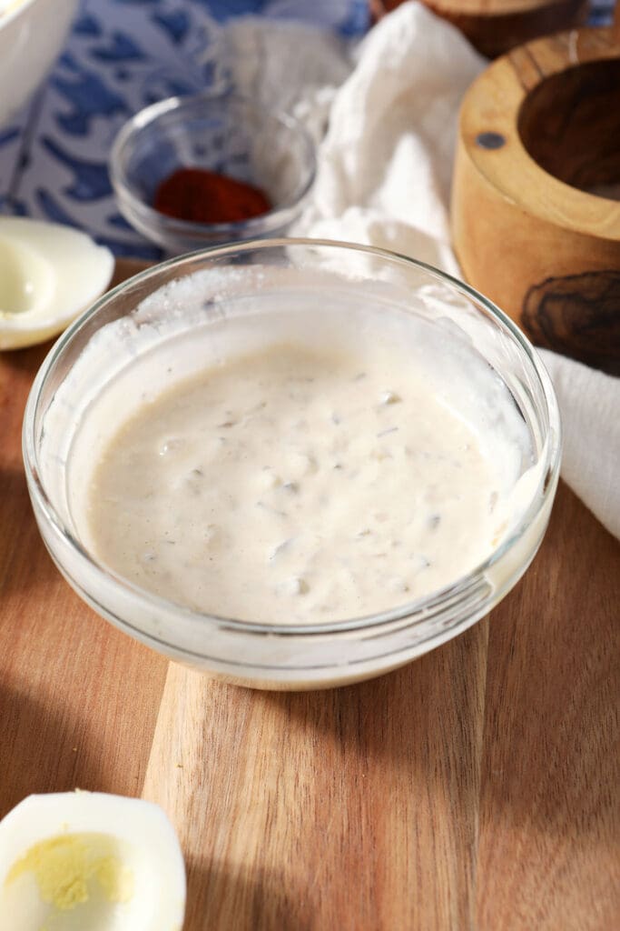 Deviled egg filling ingredients mixed in a small bowl