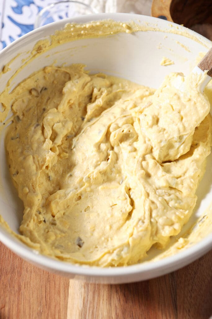 Deviled egg filling in a white bowl