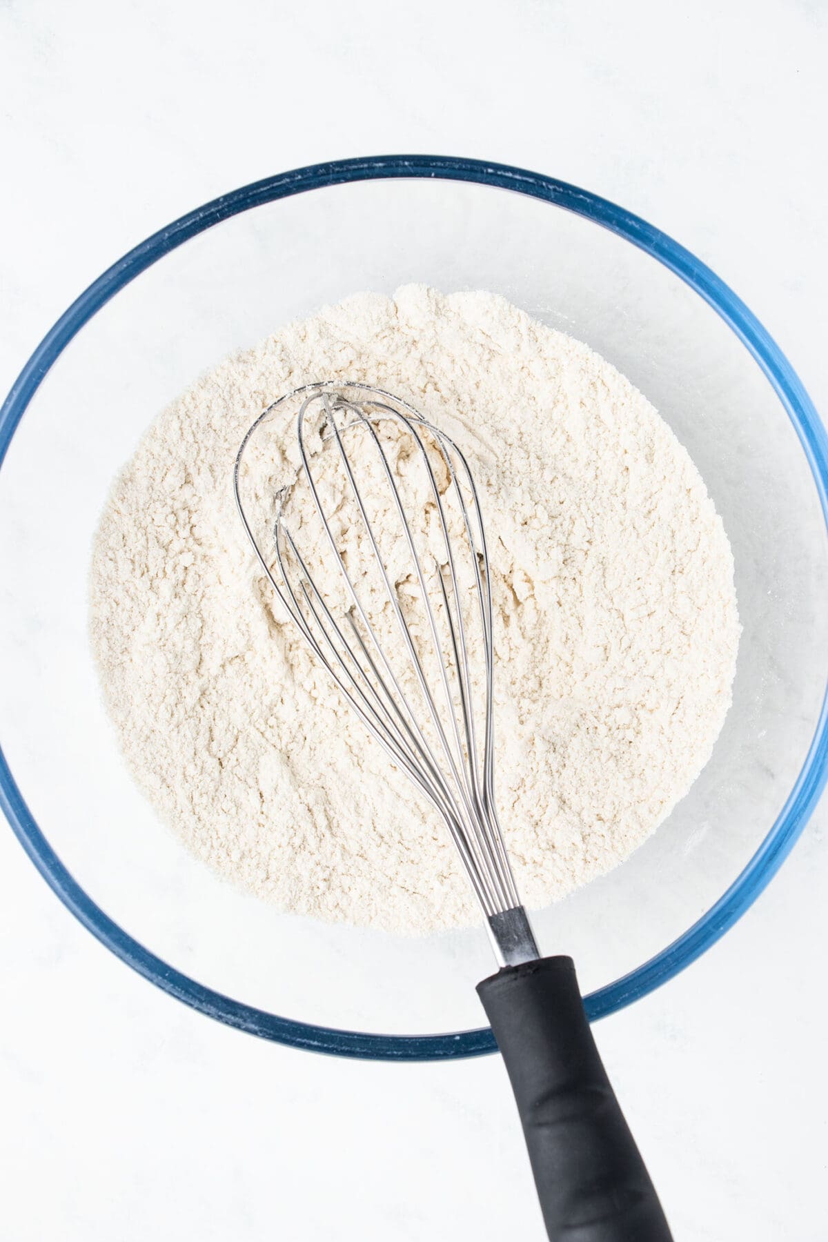 dry ingredients in a bowl with a whisk for waffle batter