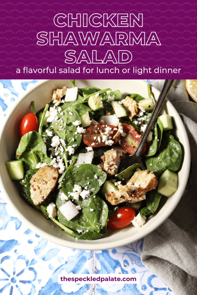 Overhead of a large bowl of shawarma chicken salad on a blue and white tiled surface with the text chicken shawarma salad a flavorful salad for lunch or light dinner