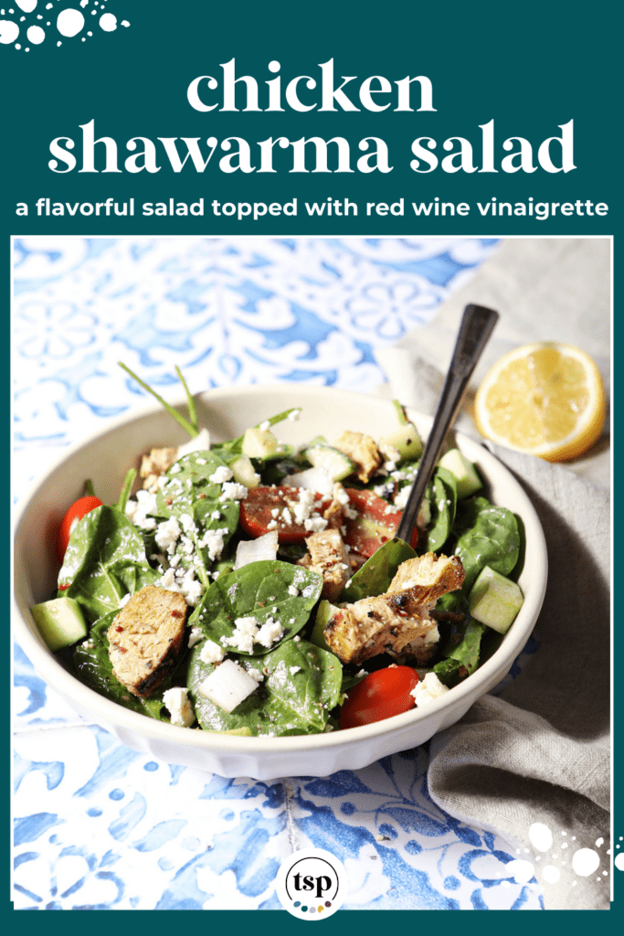 Side angle of a bowl of chicken shawarma salad on a blue and white tiled surface next to a neutral linen with the text chicken shawarma salad a flavorful salad topped with red wine vinaigrette