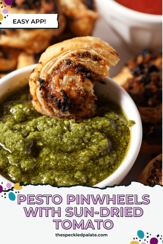 A pesto pinwheel sits in a container of pesto sauce with the text pesto pinwheels with sun-dried tomato