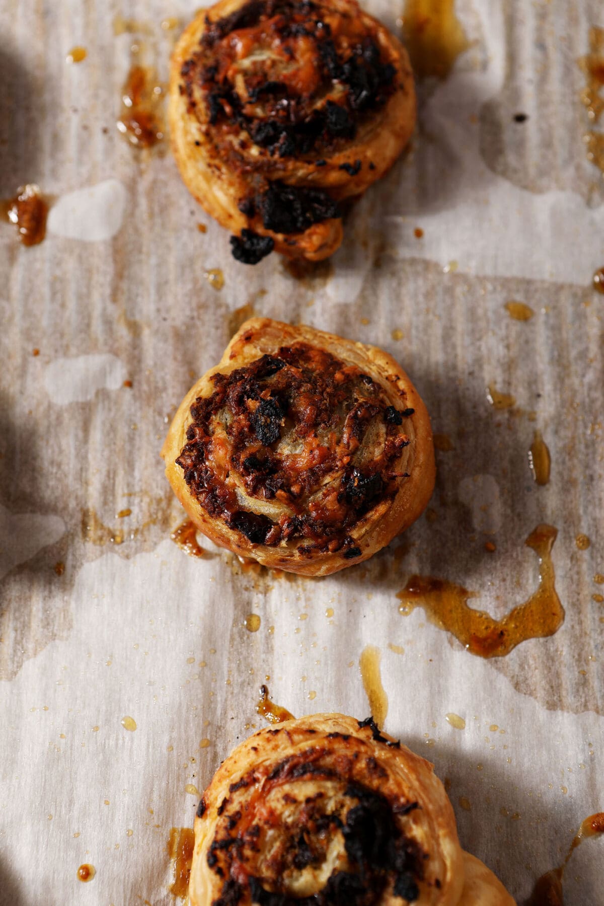 Baked pinwheels with pesto and sun-dried tomatoes on a sheet pan