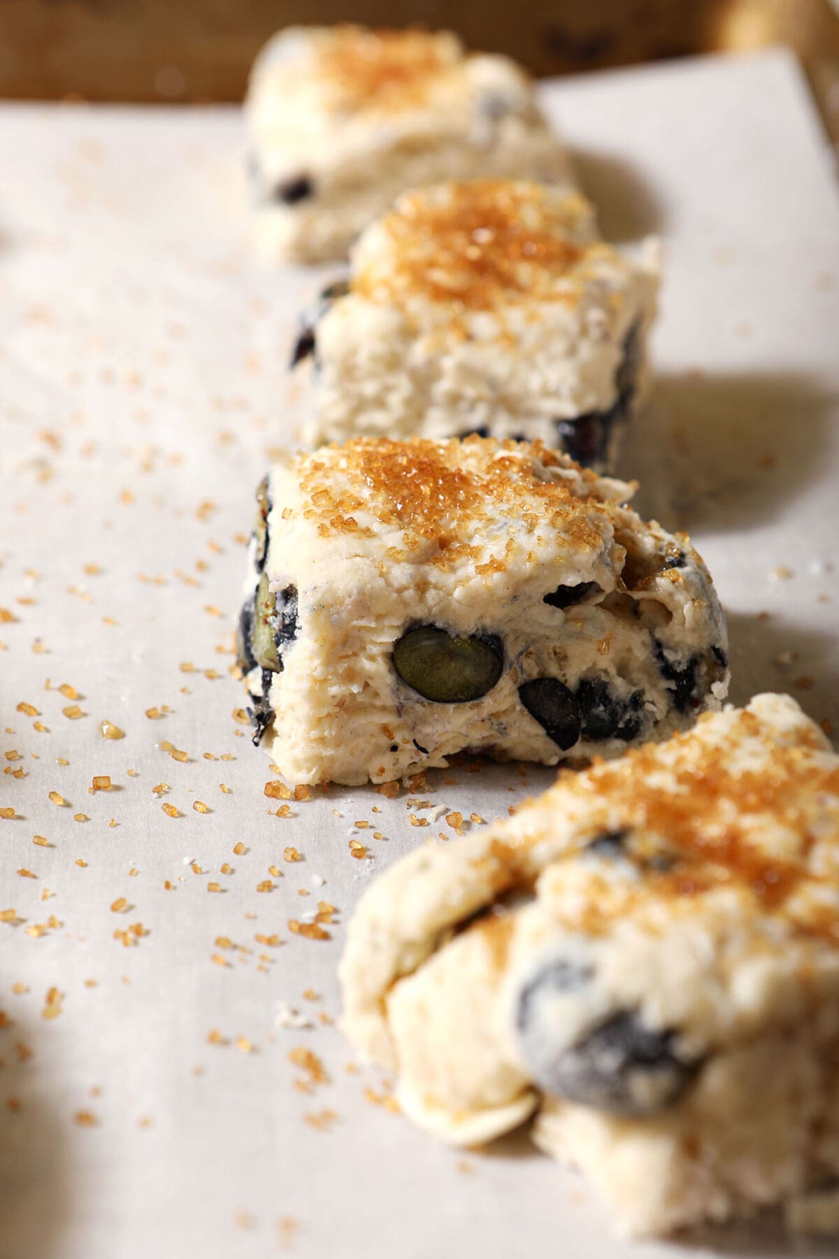 Square blueberry biscuits on a sheet pan before baking