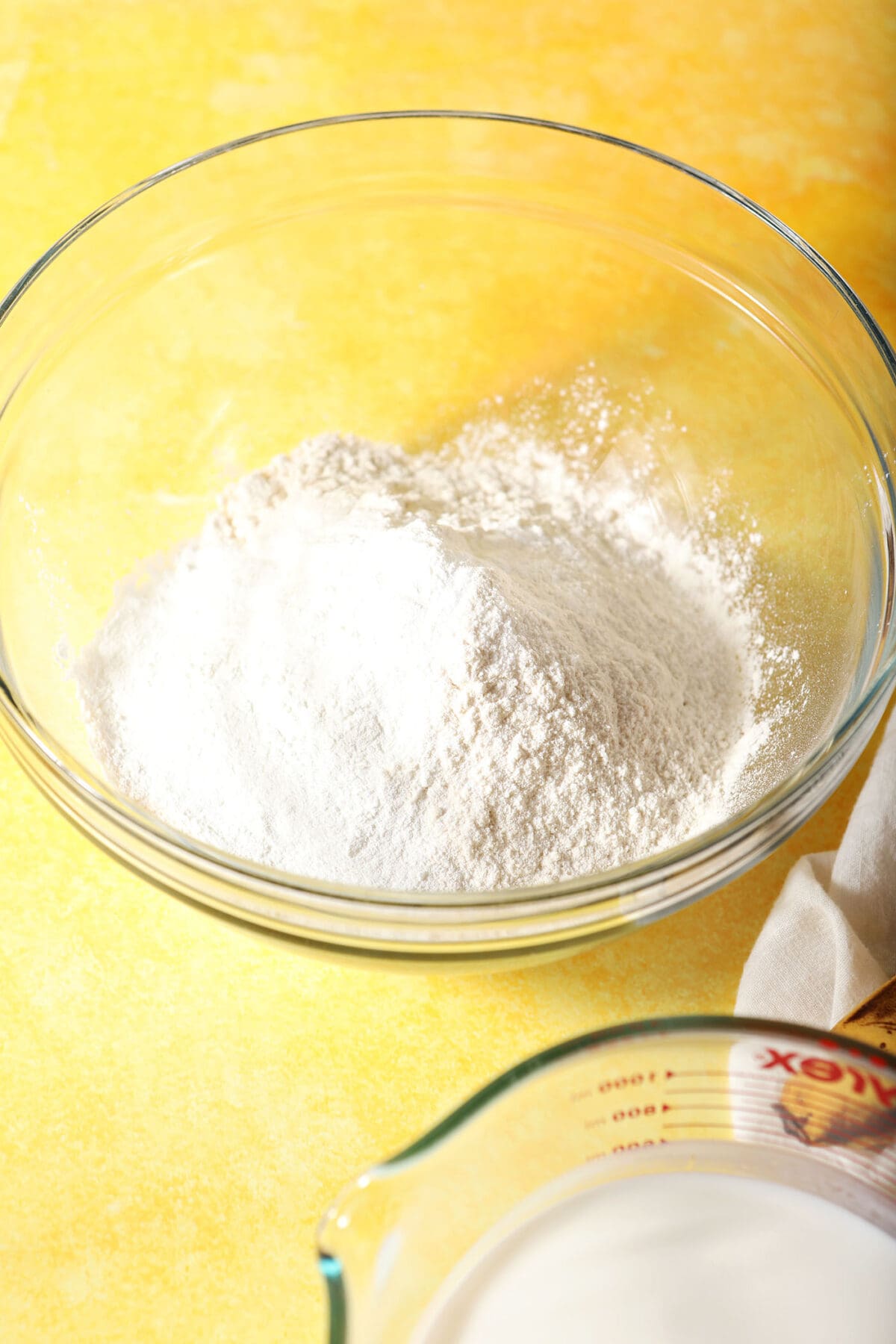 A bowl of dry ingredients on a yellow surface