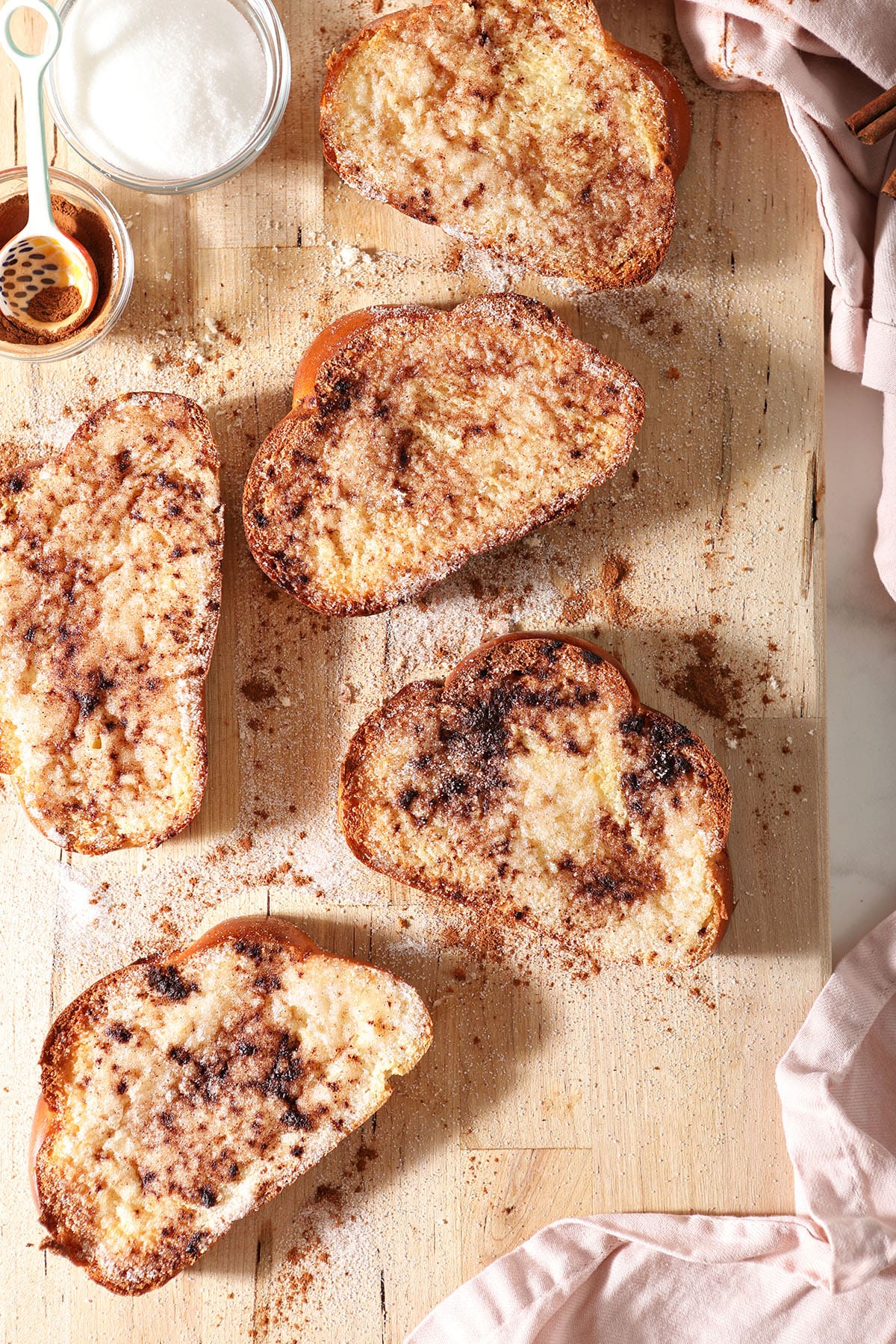 Slices of cinnamon toast on a wooden cutting board