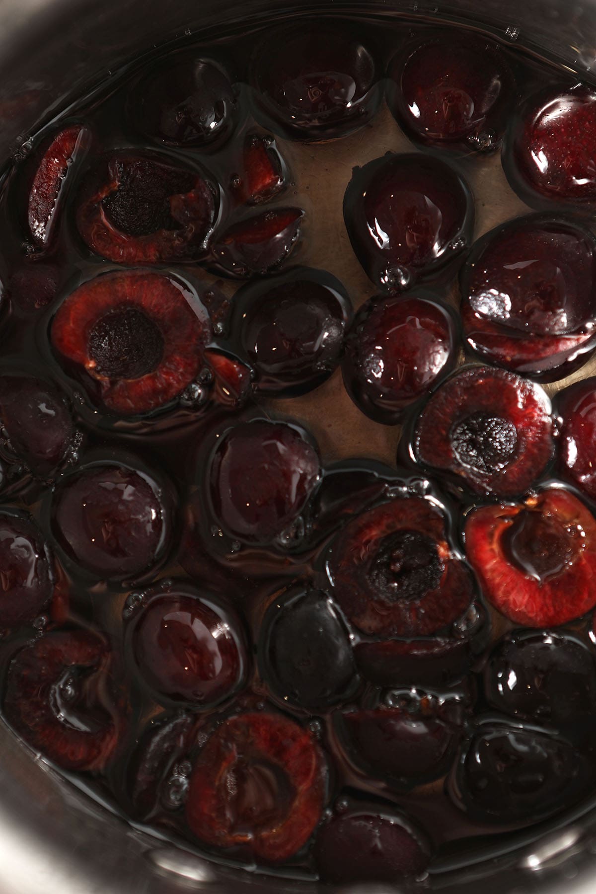 Close up of cherries infusing in a syrup