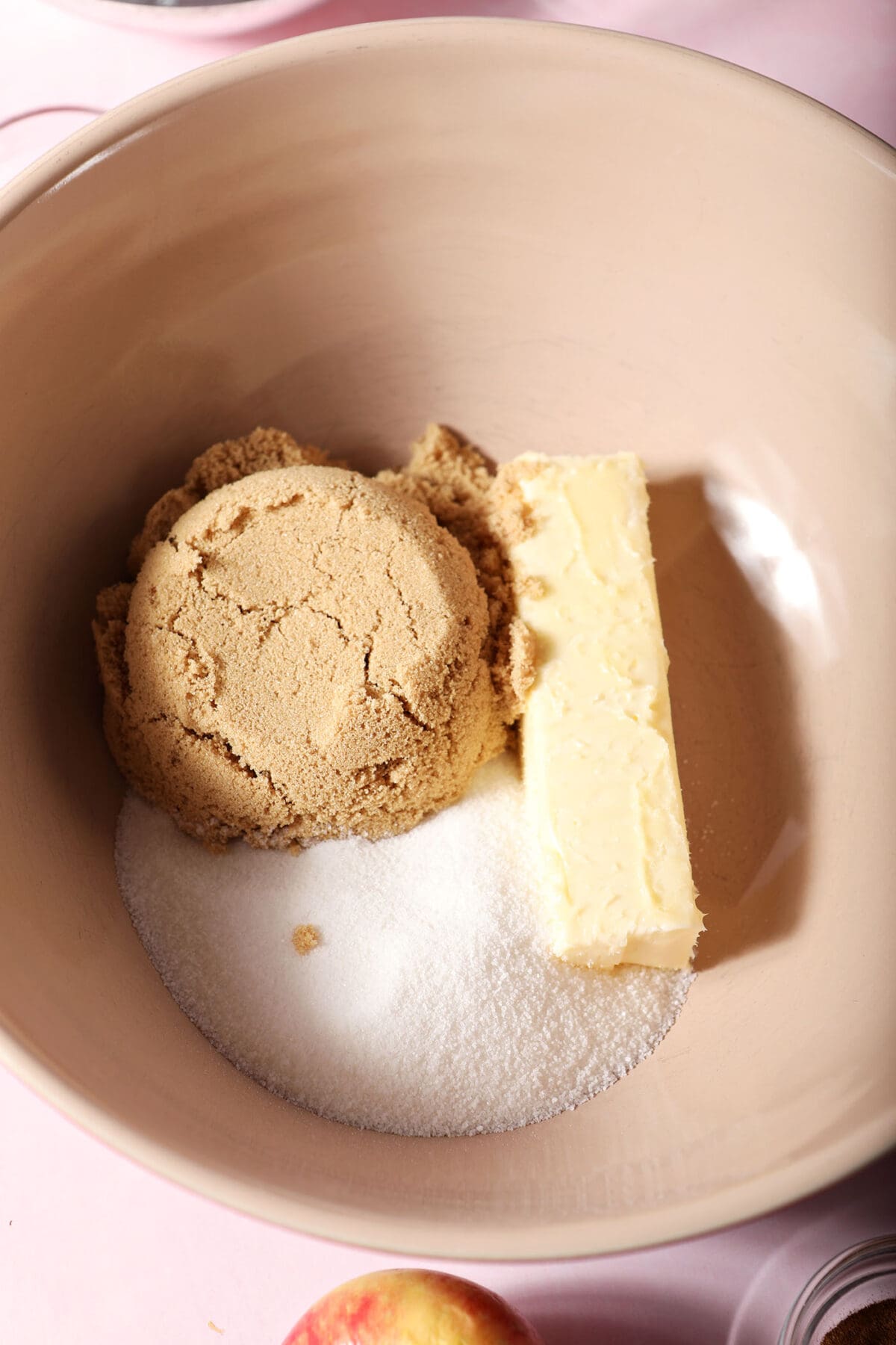 Brown sugar, granulated sugar and a stick of butter in a bowl before creaming together
