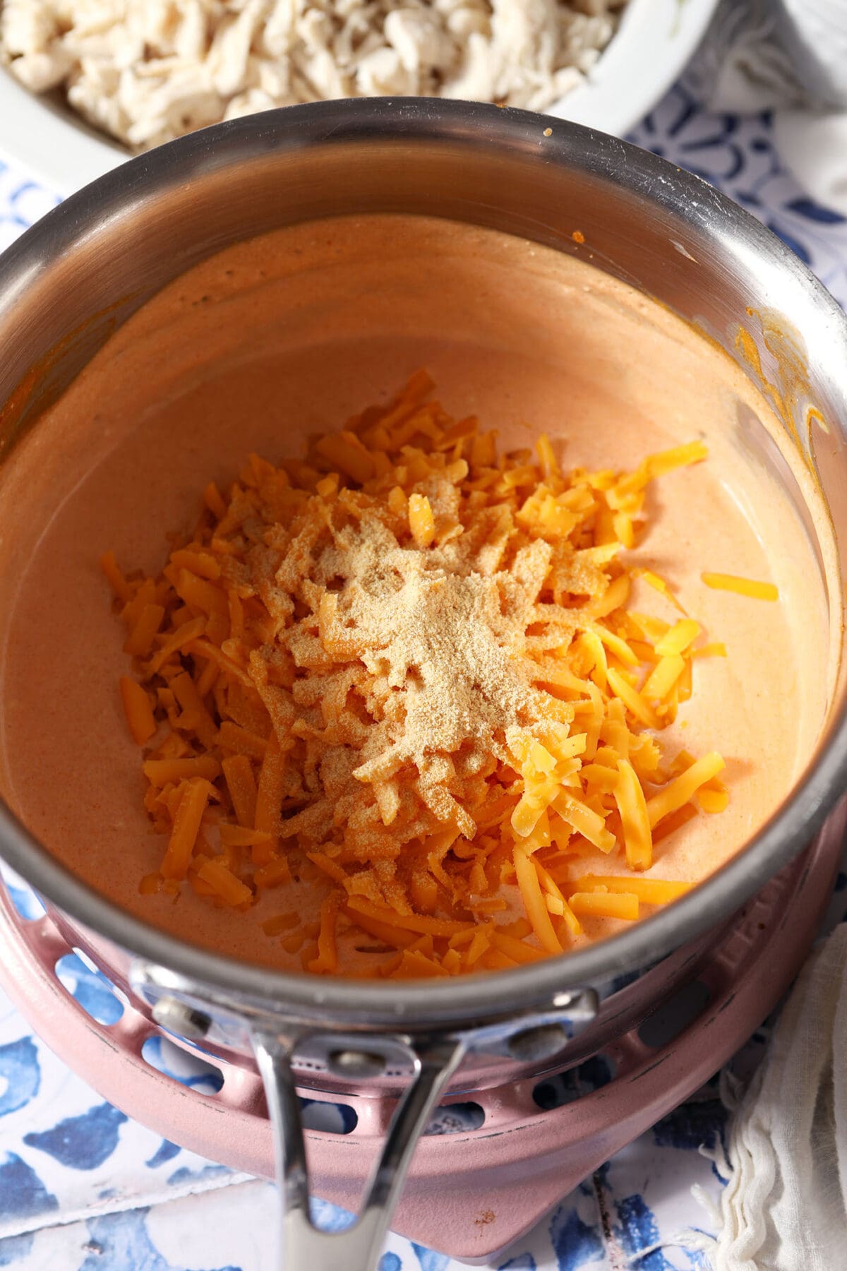 Cheese and garlic powder on top of melted ingredients in a saucepan