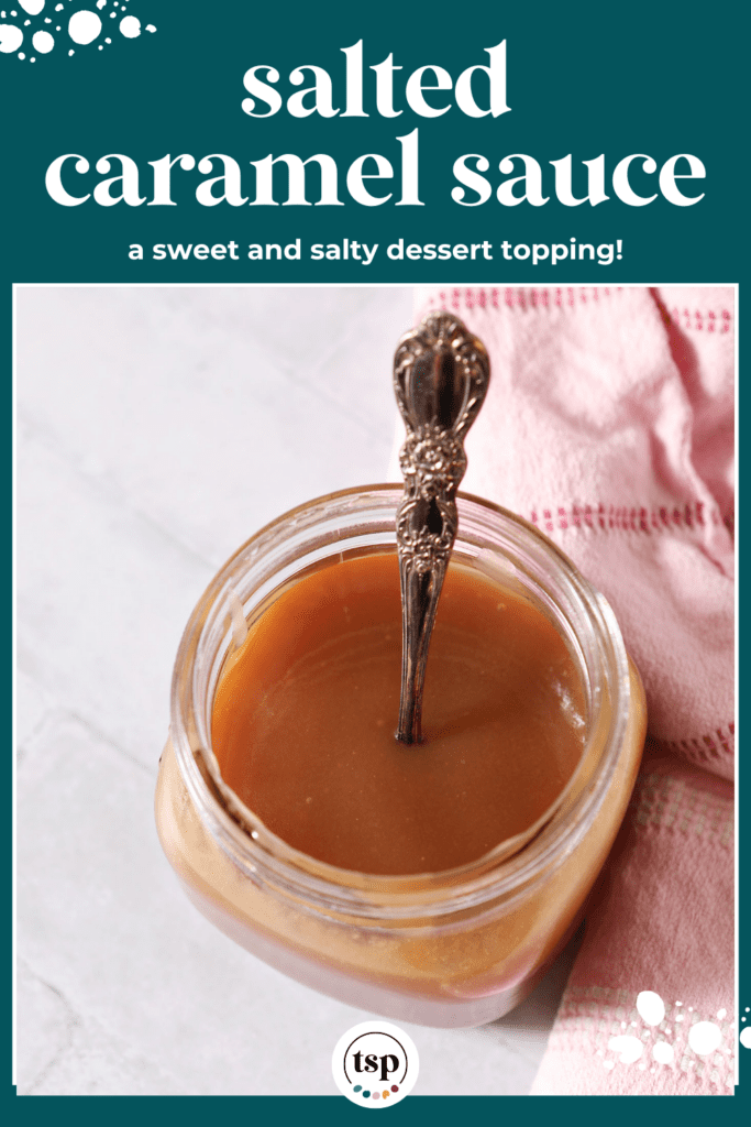 A mason jar of salted caramel sauce on a white tiled surface with a spoon inside it next to a pink linen with the text salted caramel sauce a sweet and salty dessert topping