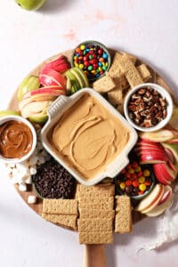 A Caramel Apple “Charcuterie” Board on a wooden surface