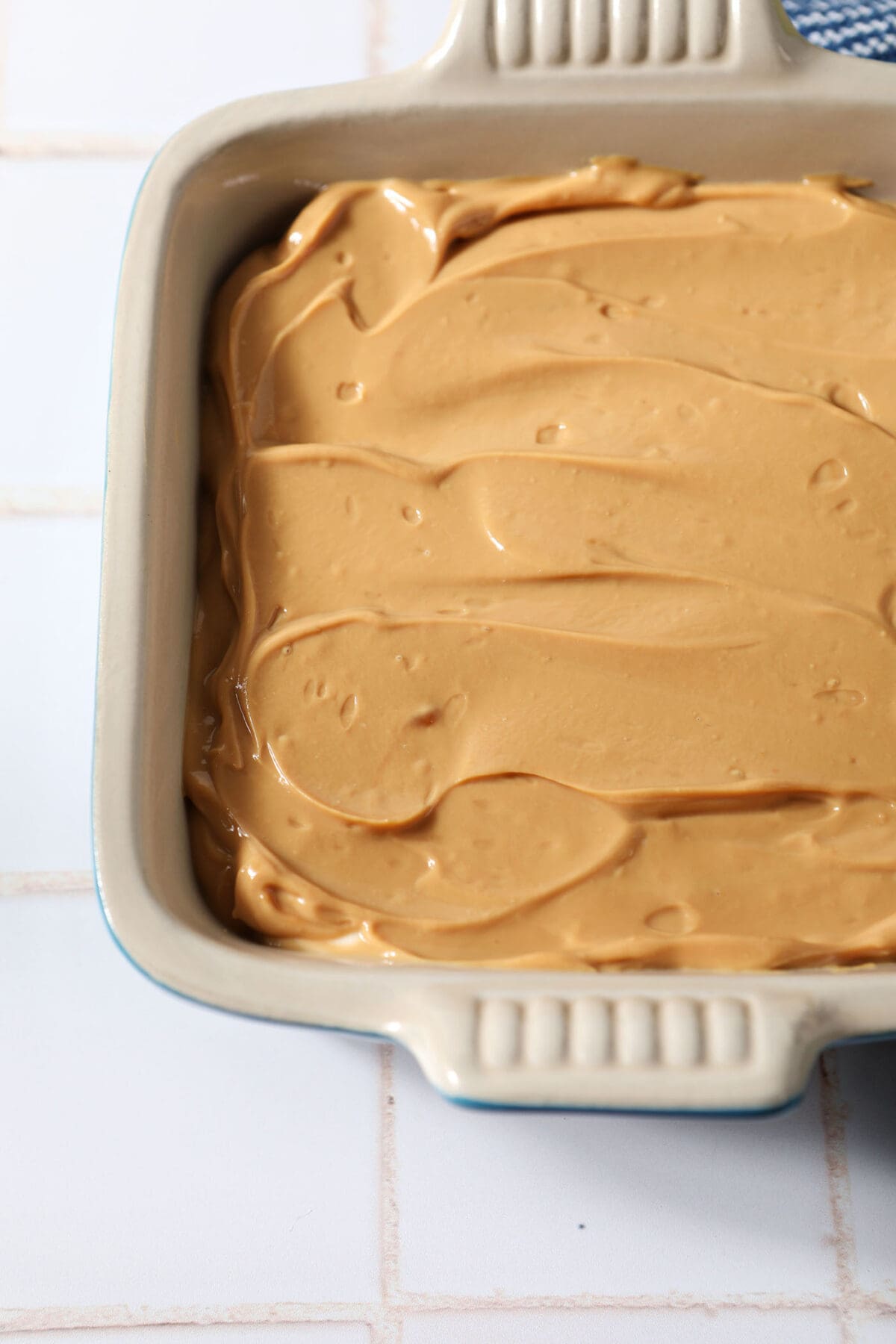 Close up of Dulce de Leche Caramel Dip in a serving dish on a white tiled surface