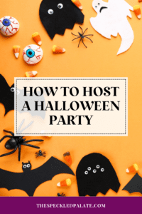 bats, spinders, eyeballs and candies on an orange surface with the text how to host a halloween party