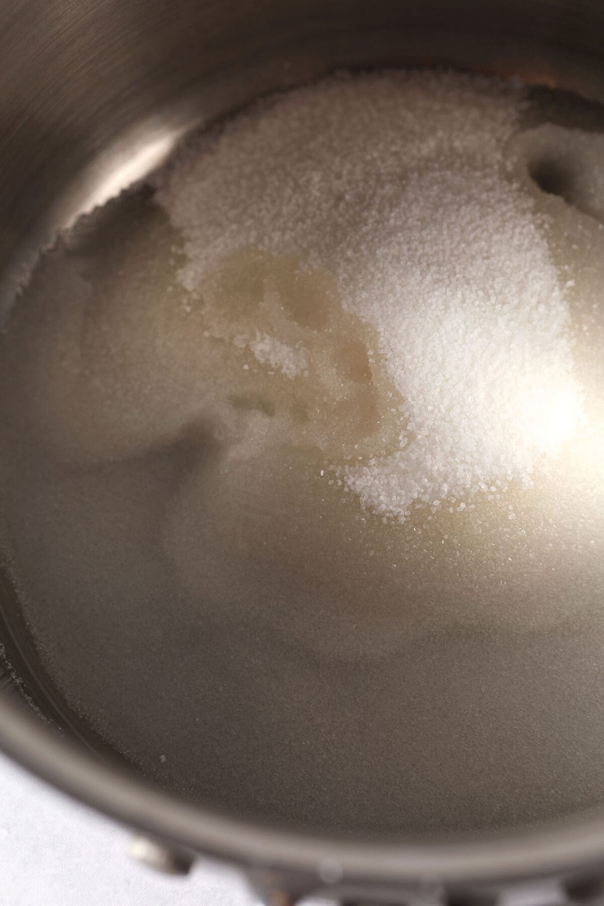 Sugar and water dissolve in a saucepan
