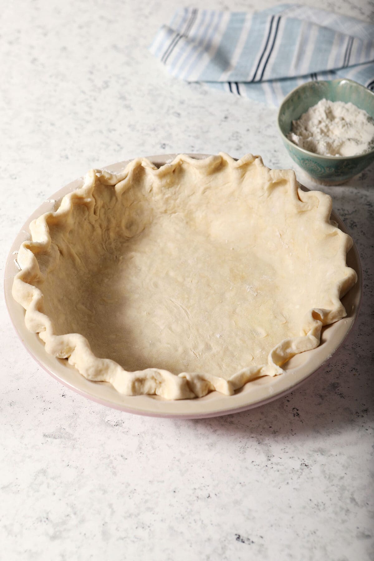 Shaped pie crust in a pie pan before baking
