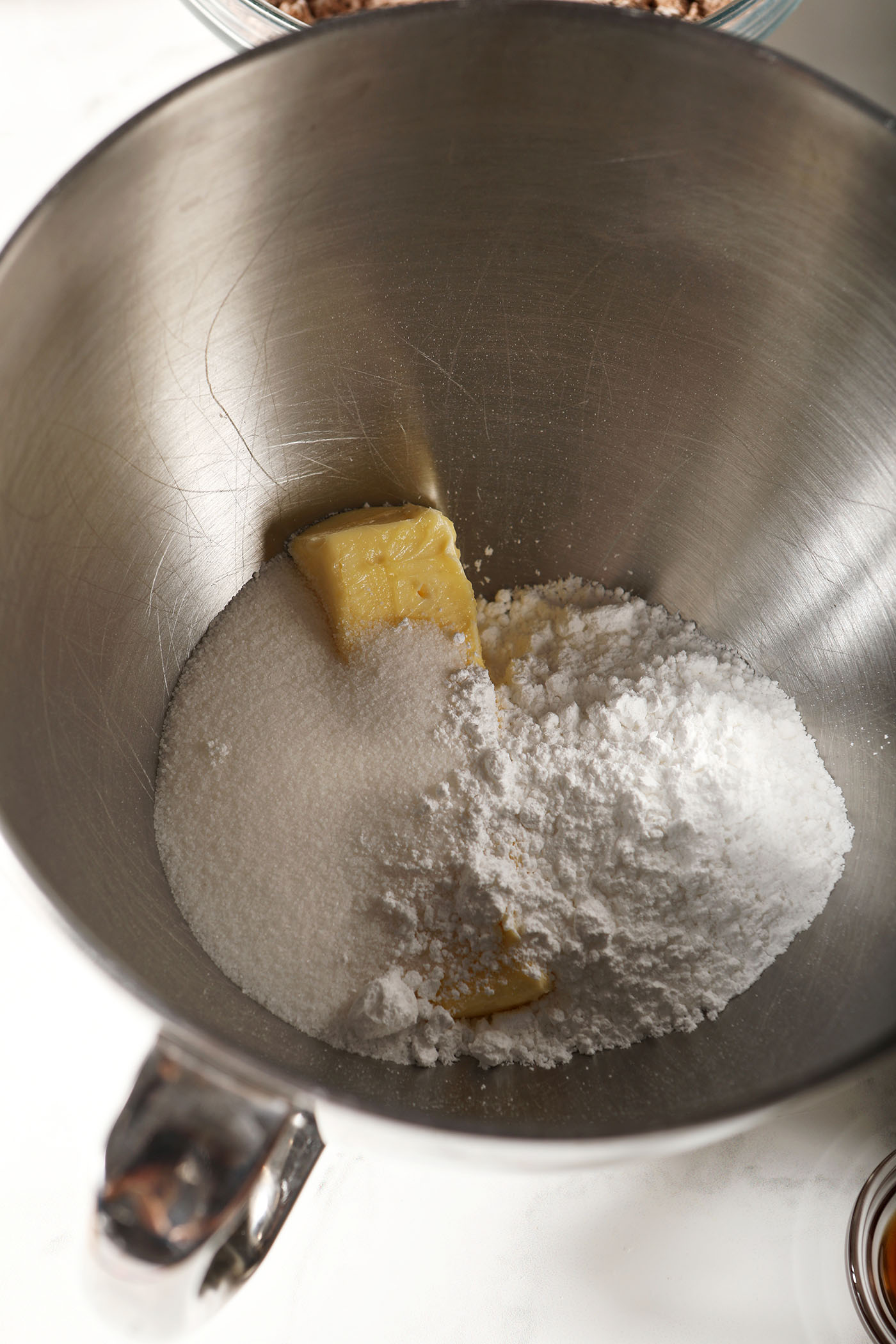 Butter with sugars in a metal bowl before mixing