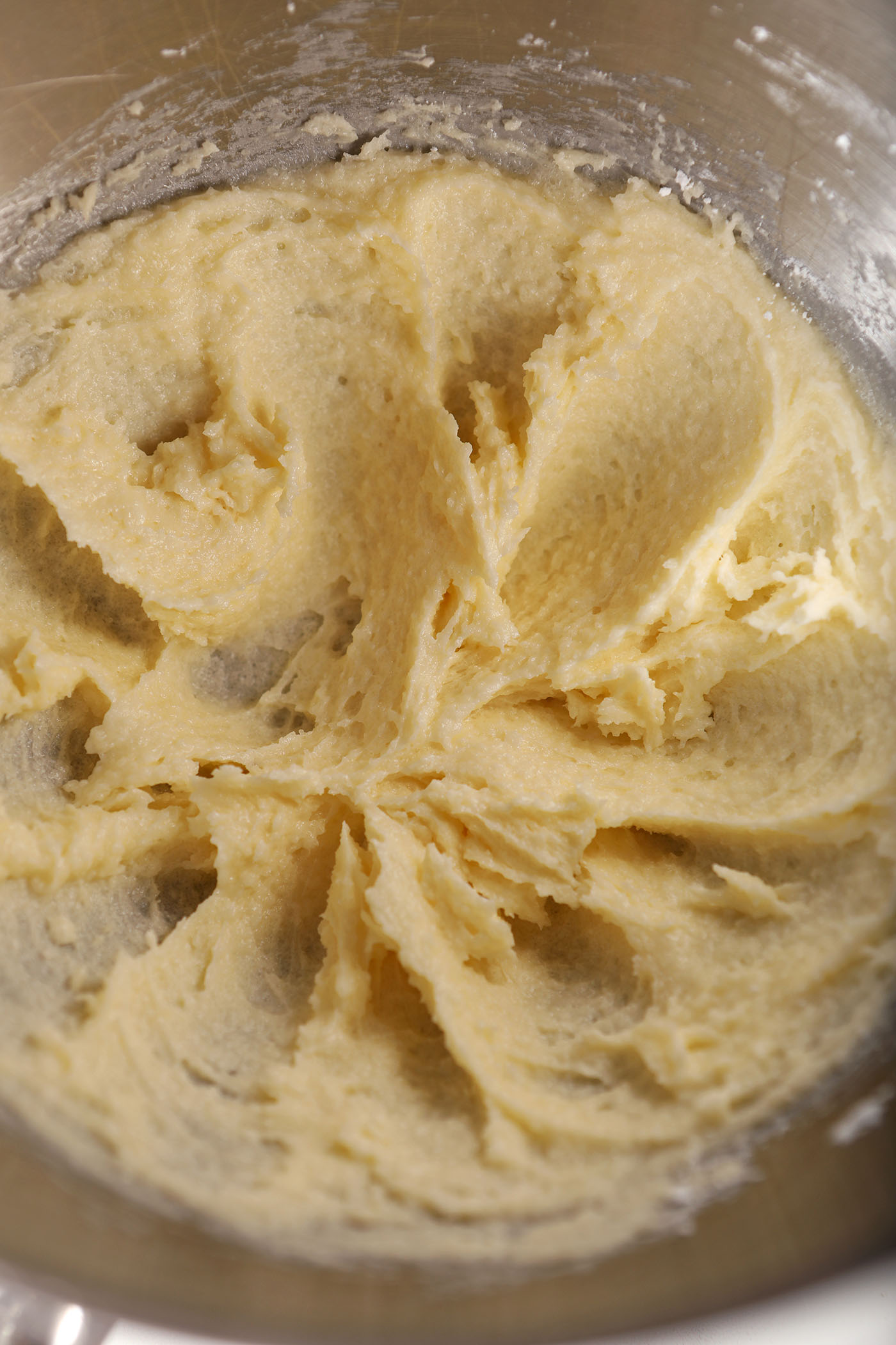 Butter and sugars in a metal bowl after creaming