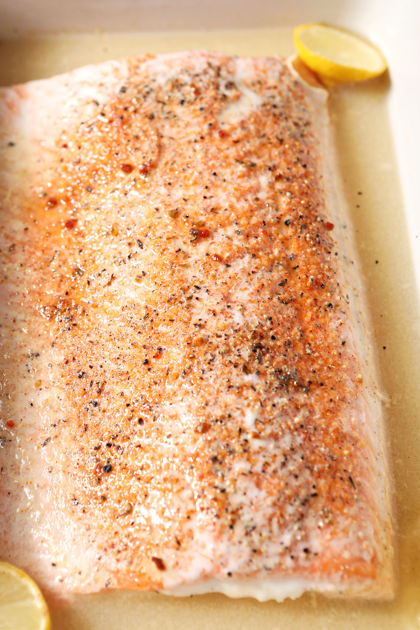 Oven Poached Salmon in a casserole dish with liquid after baking in the oven