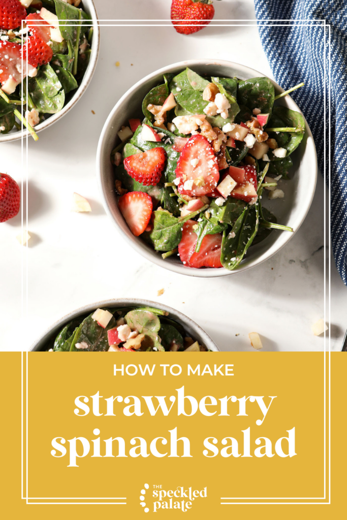 Overhead of three bowls of a strawberry spinach salad in bowls on marble next to a blue linen with the text how to make strawberry spinach salad