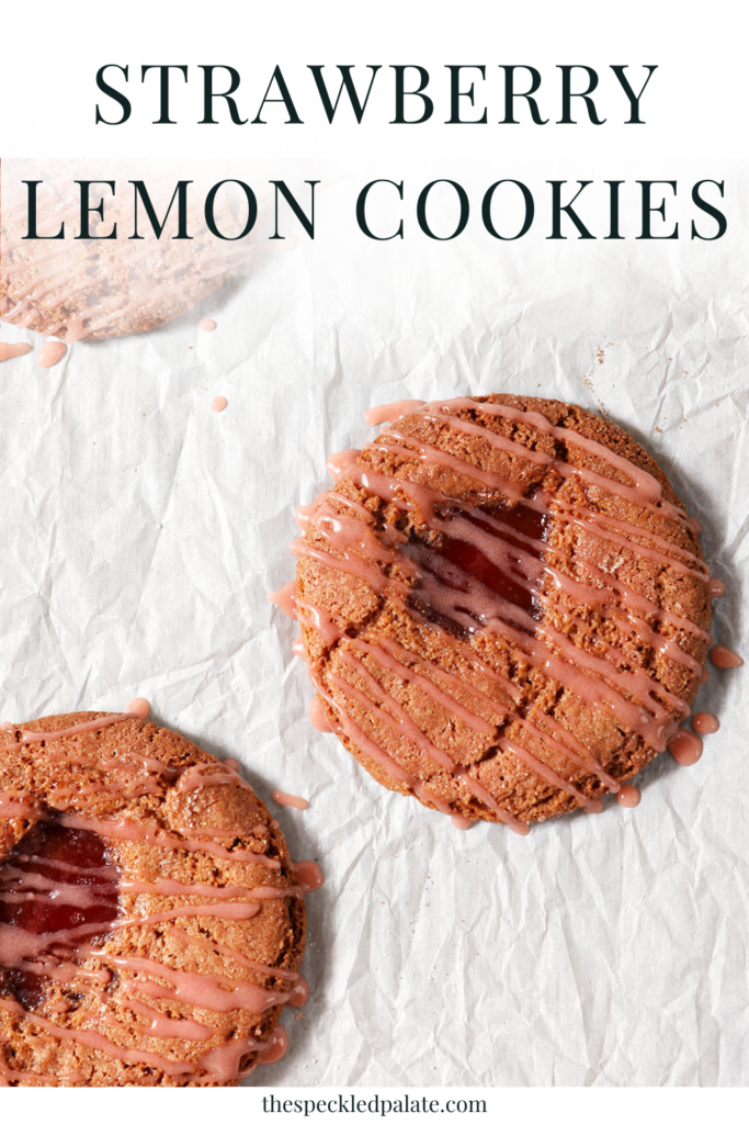Overhead of three Strawberry Lemonade Cookies on a cookie sheet after baking and frosting with the text strawberry lemon cookies