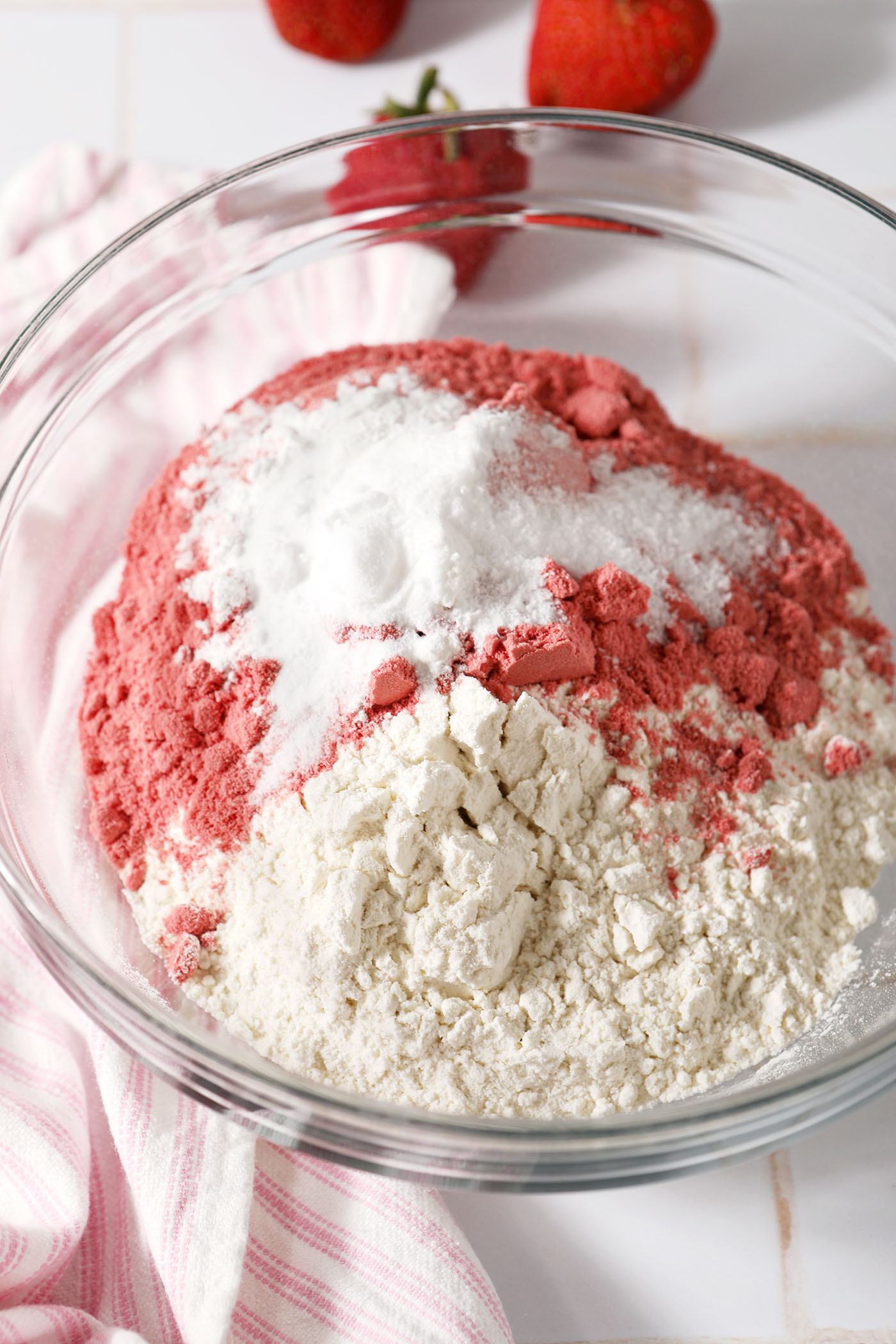 Dry ingredients including freeze-dried strawberry powder in a bowl before mixing