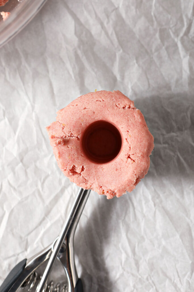 A hole in a scoop of Strawberry Lemonade Cookie dough for the filling