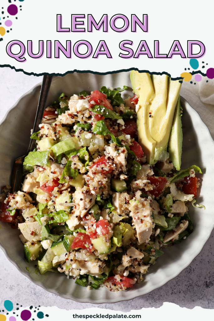 Overhead of a bowl holding a quinoa salad with chicken and veggies next to an avocado half and a lemon with the text lemon quinoa salad