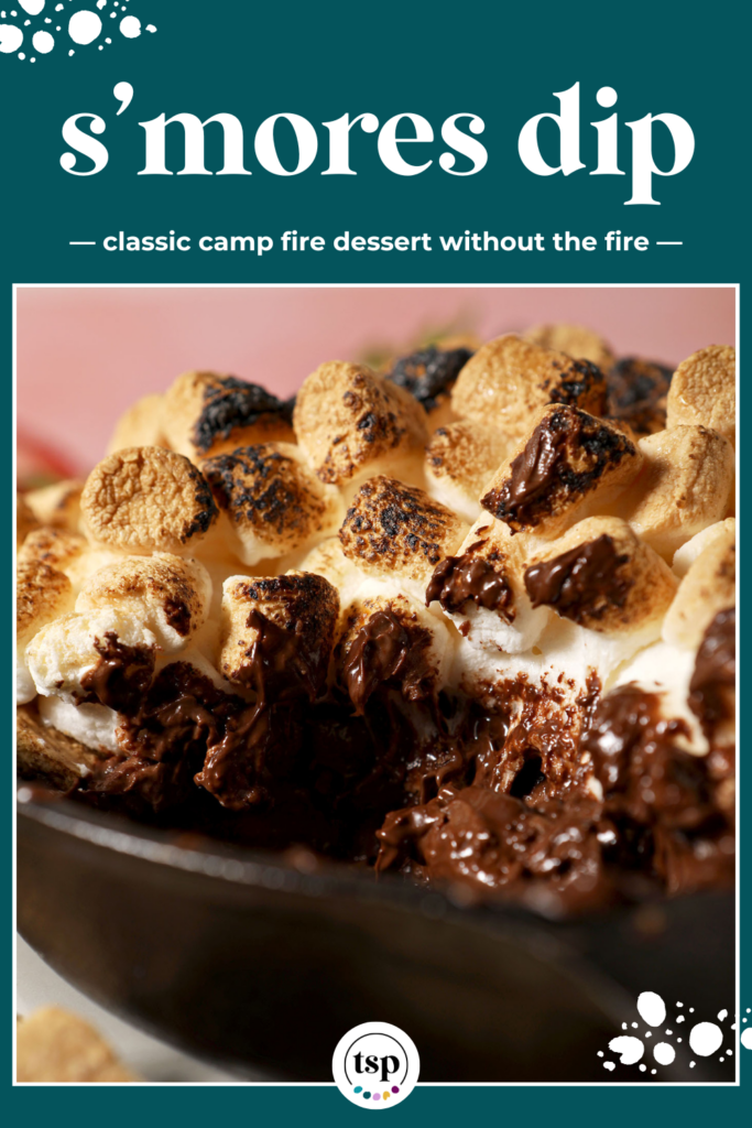 Close up of melty s’mores dip in a skillet with toasted marshmallows on top with the text s'mores dip classic camp fire dessert without the fire