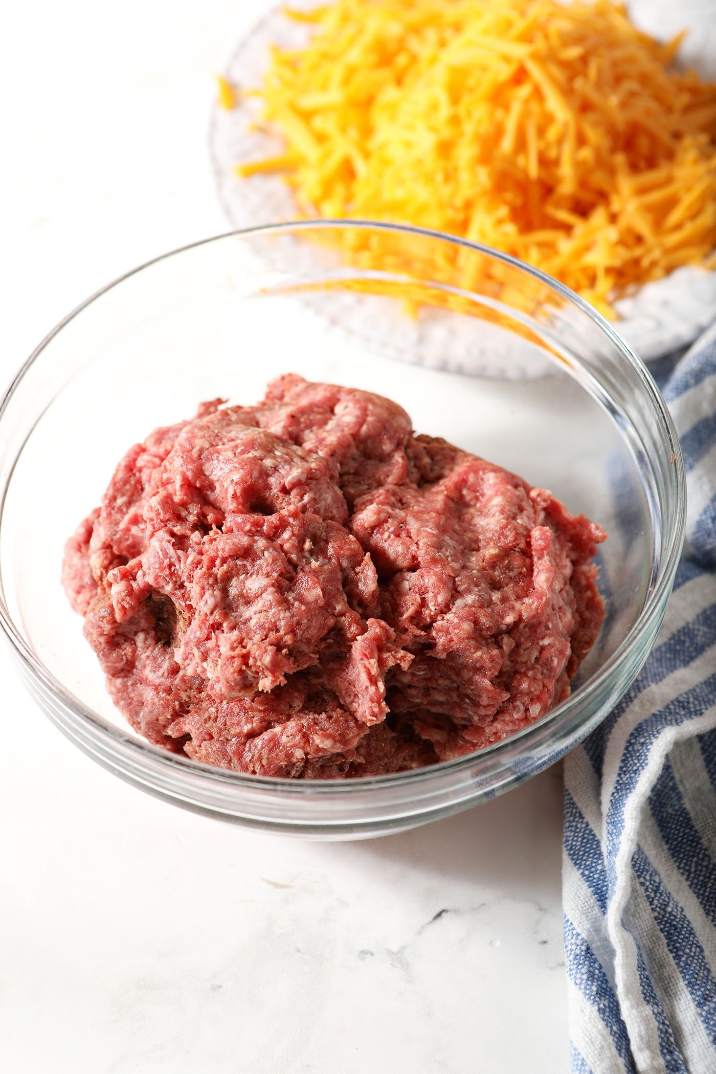 Seasoned ground beef in a bowl before forming burgers