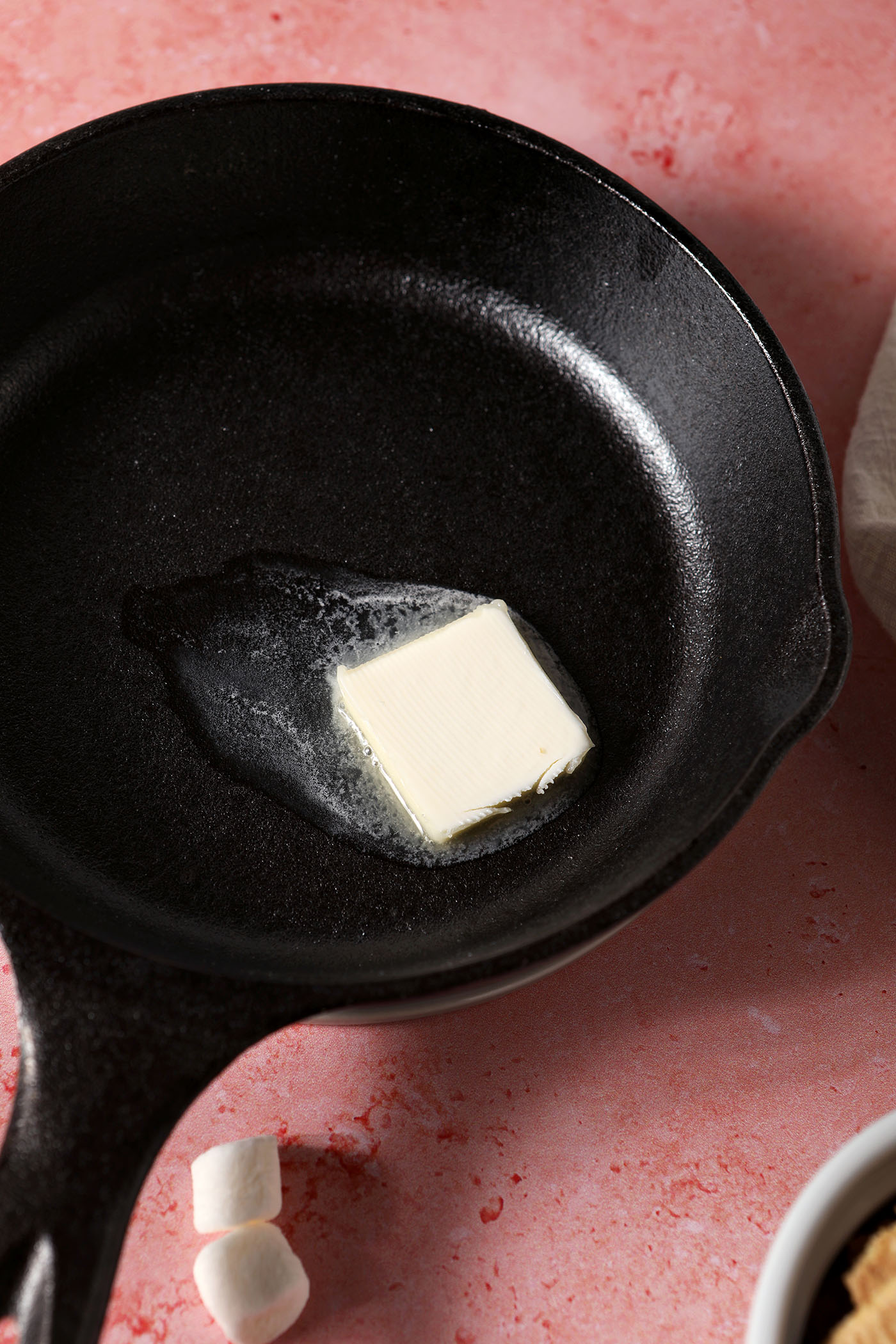 Butter melts in a small cast iron skillet